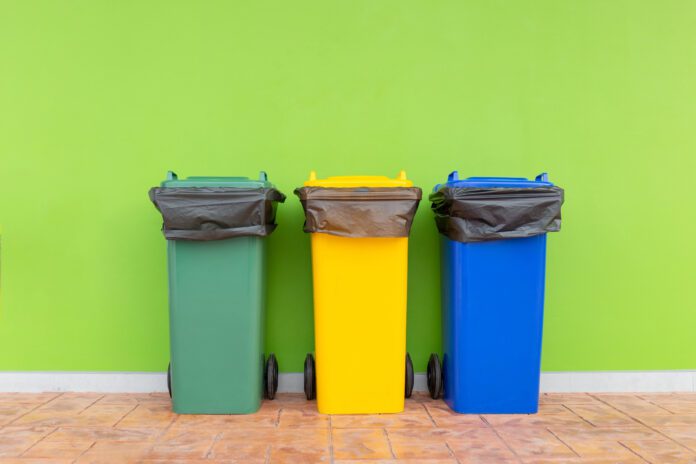 Group of colorful recycle bins green background, Different color